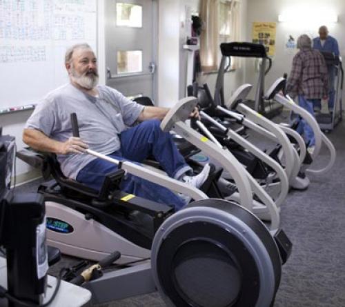 man on a seated pedal pushing machine